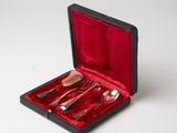 a red case with silverware in it on a white surface