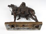 bronze statue of a man on a horse with a rider on it