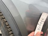 someone is measuring the width of a car tire with a tape