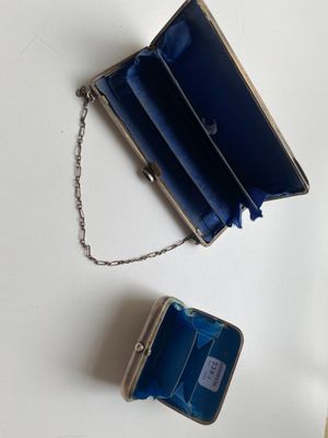a small blue purse with a chain hanging from it