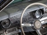 dashboard of a car with a steering wheel and dashboard gauges