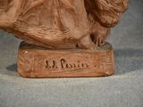 a statue of a woman holding a bird on a base