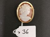 a gold and shell cameo broochle of a woman
