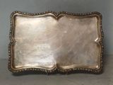 an antique silver tray with a decorative design on it
