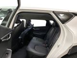 a white car with the door open and the seats down