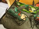 a picture of a green and black corded electric tool