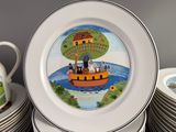 a lot of plates with a picture of a boat on them