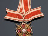 an image of a red and white ribbon with a gold star on it