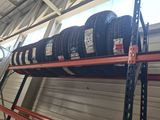 many tires stacked on a rack in the garage
