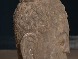 statue of a head of a person with curly hair on a table
