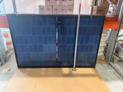 a picture of a solar panel on a pallet in a warehouse