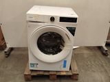 a washing machine sitting on a pallet in a room