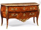 a small chest of drawers with a marble top