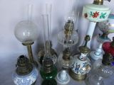 many different types of glass lamps on the table