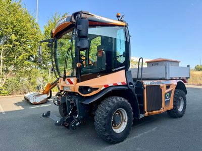a small tractor that is parked in the parking lot