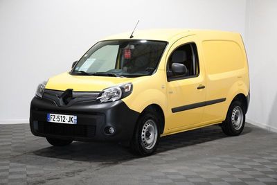 the small yellow van is parked in a room with a checkered floor