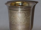 a silver cup that is sitting on a table