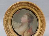 pair of miniature portraits of a woman and a man in a gold frame