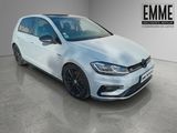 a white volkswagen golf r - line in a showroom