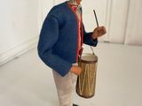 figurine of a man with a drum and a hat