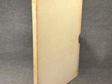 an old book sitting on top of a table next to a gray background