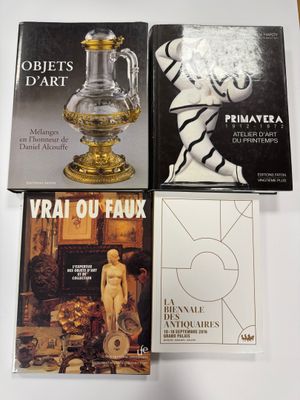 trois livres posés sur une table sur laquelle se trouve un vase