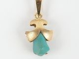 a gold pendant with a turquoise stone in the shape of an angel