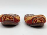 pair of red and gold slippers with embroidered design on them