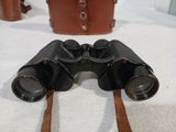 a pair of binoculars sitting on top of a white towel