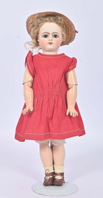 an image of a doll with a red dress and a straw hat