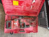 a red tool box with tools in it on the ground