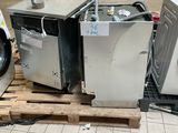 two washing machines sitting on a pallet in a warehouse