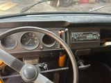 a steering wheel and dashboard of an old car
