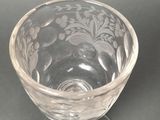 a clear glass with a pattern on it on a table