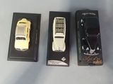 three toy cars sitting next to each other on a table