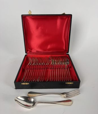 silverware in a case with red lining on a white surface
