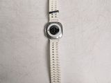 a watch that is sitting on a white surface