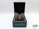 an image of a watch sitting in a box on a white surface