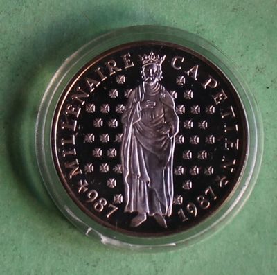 a close up of a coin on a green surface