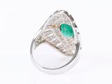 an image of a close up of a ring with a green stone