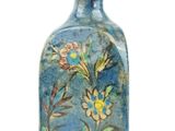 a small blue vase with a floral design on it