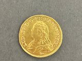 a gold coin with a woman ' s face on it