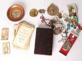 a table with a lot of items on it including a book and a medal