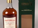 an empty bottle of imperial whisky next to a box
