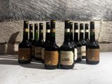 several bottles of wine are lined up on a table