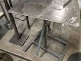 a metal table that is sitting in the middle of a room