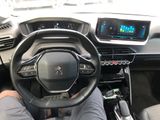 someone is sitting in the driver ' s seat of a car with their feet on the steering wheel
