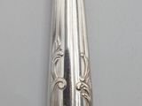 a silver spoon with a silver handle on a white table