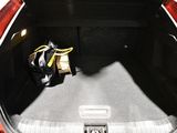 a trunk of a car with a bag of luggage in it