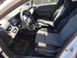 the interior of a white car with black seats and a black floor mat